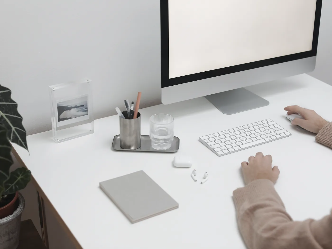 Finance software open on a laptop and a monitor at a tidy workstation