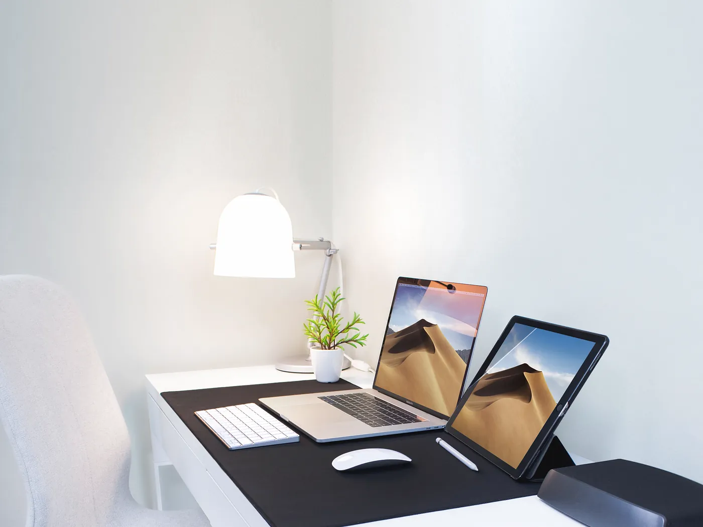 Tidy desk with a laptop and tablet set up for accounting and reporting work